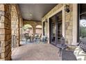 Charming stone patio featuring comfortable seating, stylish decor, and arched openings, perfect for outdoor entertaining at 1030 S Adams St, Denver, CO 80209