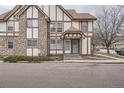 Street view of a Tudor-style townhome with stone accents and a welcoming entrance at 17936 Becket Dr, Parker, CO 80134