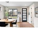 Bright dining area featuring a modern light fixture, wood floors, and a view to the outside at 2231 W 36Th Ave, Denver, CO 80211