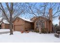 Ranch style home with a two-car garage and mature trees in the front yard at 7900 E Dartmouth Ave # 76, Denver, CO 80231