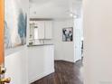 Convenient kitchenette with a wine rack, granite counters, and modern fixtures at 1000 E 1St Ave # 407, Denver, CO 80218