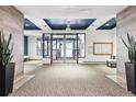Well-lit condo lobby featuring neutral tones, a mail center, and a view of the exterior at 1000 E 1St Ave # 407, Denver, CO 80218