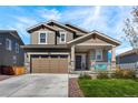 Beautiful two-story home showcasing a spacious driveway, covered porch, and a well-manicured front yard at 1043 High Point Trl, Elizabeth, CO 80107