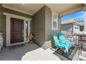 Welcoming front porch with seating, a decorative welcome bear and charming details at 1043 High Point Trl, Elizabeth, CO 80107