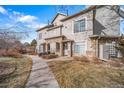 Townhouse exterior with stone accents and landscaping at 9468 E Florida Ave # 1047, Denver, CO 80247