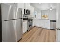 Modern kitchen features stainless steel appliances, white cabinets, and granite countertops at 2184 Alyssa St, Fort Lupton, CO 80621