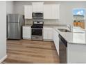 Modern kitchen features stainless steel appliances and granite countertops at 2184 Alyssa St, Fort Lupton, CO 80621