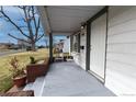 Charming covered porch with chairs, ideal for enjoying the neighborhood view at 5185 Alcott St, Denver, CO 80221