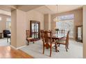 Dining space with wood table set and hutch plus carpet flooring at 3494 S Otis Ct, Lakewood, CO 80227