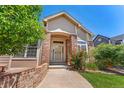 Welcoming front entry with a brick facade and decorative door at 3494 S Otis Ct, Lakewood, CO 80227