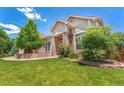 Lovely exterior of home with beautiful landscaping and manicured lawn at 3494 S Otis Ct, Lakewood, CO 80227