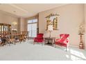 Bright living area with neutral carpet, tapestry and classic furniture at 3494 S Otis Ct, Lakewood, CO 80227