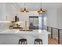Modern kitchen boasting sleek white cabinets, quartz counters, and stainless steel appliances at 5142 W 44Th Ave, Denver, CO 80212