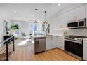 Bright open kitchen featuring modern cabinets, stainless appliances, and eat-in kitchen at 5142 W 44Th Ave, Denver, CO 80212