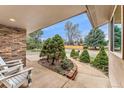 Inviting front porch featuring well-kept landscaping and a brick accent wall at 7106 S Kendall Blvd, Littleton, CO 80128