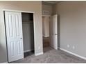 Bedroom features plush carpeting and a closet for ample storage at 1783 Jennifer St, Brighton, CO 80601
