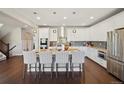 Spacious kitchen with a large center island, stainless appliances, and stylish pendant lighting fixtures at 17829 W 95Th Pl, Arvada, CO 80007