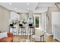Bright kitchen with stainless steel appliances, breakfast bar, and stylish stools offering a functional space at 6382 W Byers Pl, Lakewood, CO 80226
