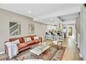 Inviting living room and kitchen combo, with hardwood floors and a cozy seating area, complete with natural light at 6382 W Byers Pl, Lakewood, CO 80226