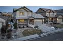 Two-story house with gray siding, stone accents, and a two-car garage at 13717 Ashgrove Cir, Parker, CO 80134