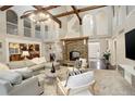 Grand living room with a stone fireplace, soaring ceilings, and an open-concept design at 1036 Lexington Ave, Westminster, CO 80023