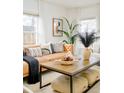 Bright living room showcasing a leather couch, decorative pillows, and a wooden coffee table with unique accents at 2774 W Irvington Pl, Denver, CO 80219