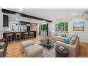 Cozy living room with an open floorplan, a modern kitchen, and scenic views from large windows at 1111 Monroe St, Denver, CO 80206