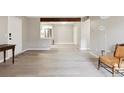 Open-concept living space featuring light gray walls and modern flooring at 3335 S Ammons St # 103, Lakewood, CO 80227