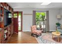Comfortable living room with hardwood floors, built-in shelving, and a large window at 8764 W 95Th Ave, Broomfield, CO 80021