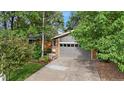 Brick ranch home with gray garage door, landscaping, and a well-manicured lawn at 1746 Shavano St, Longmont, CO 80504