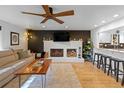 Cozy living room featuring a fireplace, hardwood floors, and comfortable seating at 1746 Shavano St, Longmont, CO 80504