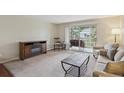 Inviting living room with a fireplace and access to a charming balcony at 580 S Clinton St # 12C, Denver, CO 80247