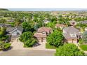 Expansive aerial shot showcasing a suburban home with mature trees and a peaceful neighborhood setting at 10565 Kalahari Ct, Lone Tree, CO 80124
