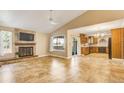 Inviting living room boasts a cozy fireplace, vaulted ceilings, and access to the kitchen at 2840 S Heather Gardens Way # A, Aurora, CO 80014