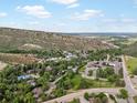 A captivating aerial view showcasing the picturesque neighborhood and scenic mountain backdrop at 109 Bear Creek Ln, Morrison, CO 80465