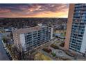 Stunning aerial view of the building with balconies and sunset; lush landscaping surrounds the property at 4800 E Hale Pkwy # 712N, Denver, CO 80220
