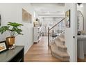 Inviting entryway featuring hardwood floors, a staircase, and views into the living room at 1039 Highview Dr, Erie, CO 80516