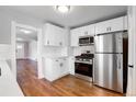 Modern kitchen features white cabinets, stainless steel appliances, and hardwood floors at 2101 S Lafayette St, Denver, CO 80210