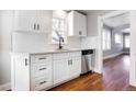 Renovated kitchen with white shaker cabinets, quartz countertops, and stainless steel appliances at 2101 S Lafayette St, Denver, CO 80210