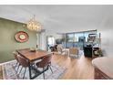 Open dining room with wood table and chandelier, adjacent to living area at 1020 15Th St # 27E, Denver, CO 80202