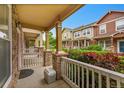 View from porch, featuring stone accents, townhomes, and landscaped front yards at 22801 E Briarwood Pl, Aurora, CO 80016