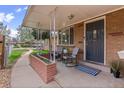 Charming front porch seating area with brick planter, perfect for relaxing or welcoming guests at 3667 Hudson St, Denver, CO 80207
