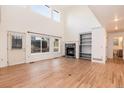 This is a view of a living room with wood floors, a fireplace, and access to a bathroom at 5294 S Espana St, Centennial, CO 80015