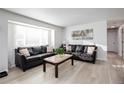 Inviting living room features a large window and laminate wood flooring at 5986 S Cook St, Littleton, CO 80121