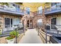 Close-up view of the building entrance with brick accents, disability access, and secure entry system at 9019 E Panorama Cir # D218, Englewood, CO 80112