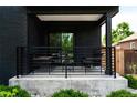 Inviting covered porch featuring modern railings and comfortable seating, perfect for relaxing outdoors at 2645 Eudora St, Denver, CO 80207