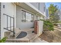 Cozy home entrance with a sturdy railing, neutral siding, and a tidy, well-maintained exterior at 68 S Moline St, Aurora, CO 80012