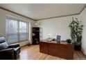 Office with wooden desk, bookshelf, a comfortable black leather chair and plenty of natural light at 1150 W 127Th Ct, Denver, CO 80234