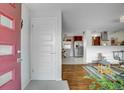 Inviting foyer with hardwood floors and a view into the dining area and kitchen at 218 Pikes Peak Pl, Longmont, CO 80504