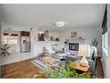 Bright and airy living room featuring a fireplace, hardwood floors, and an open layout at 218 Pikes Peak Pl, Longmont, CO 80504